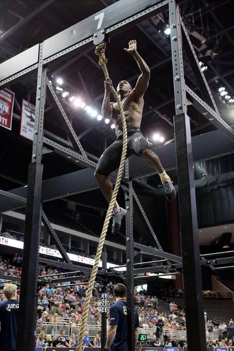Iron Athlete Elijah EZ Muhammad Climbs a rope at the CrossFit Regional Competition